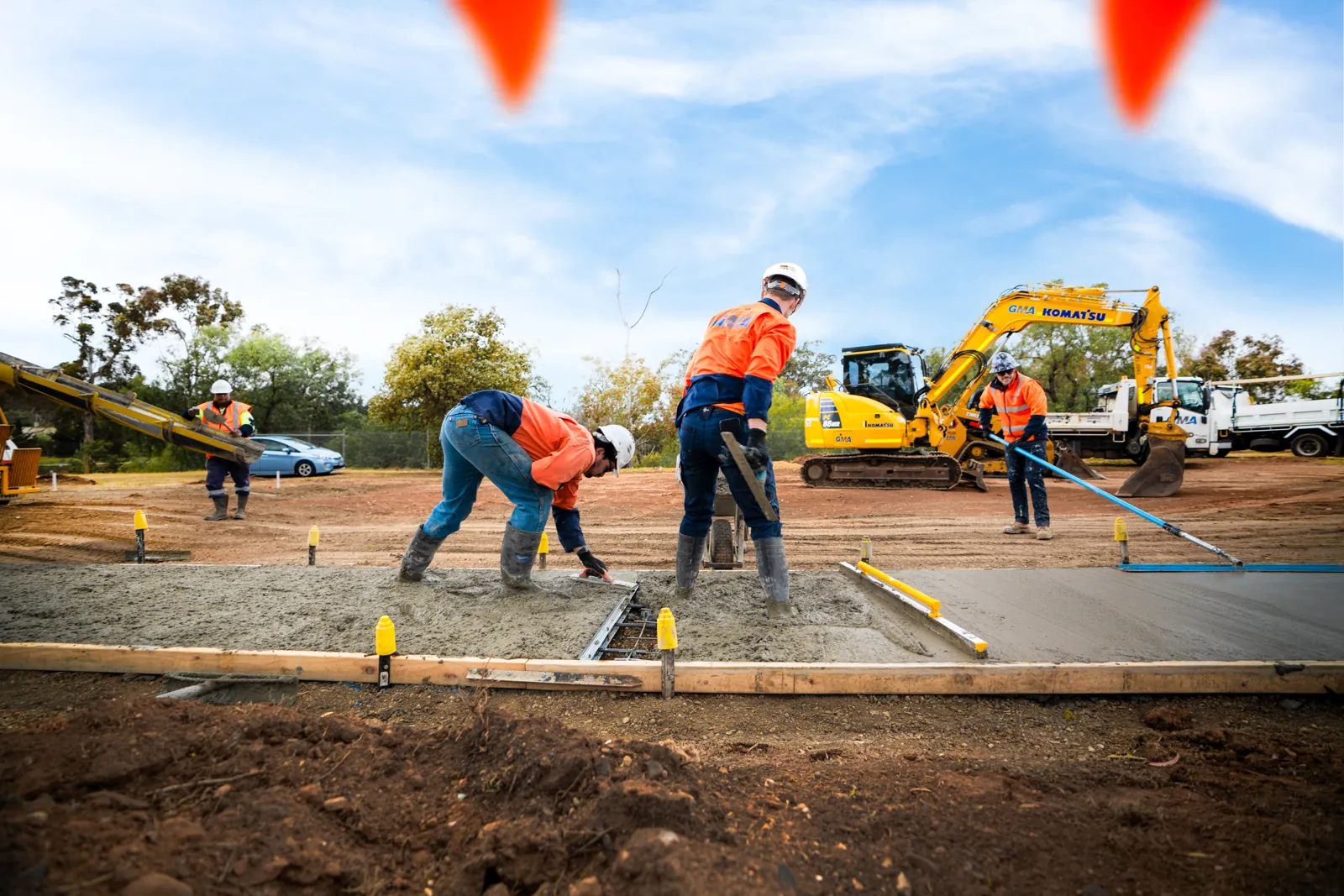 Crew placing and finishing a concrete pour on site